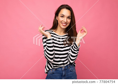 Portrait of positive cheerful fashionable woman in casual clothes isolated on pink background with 77804754