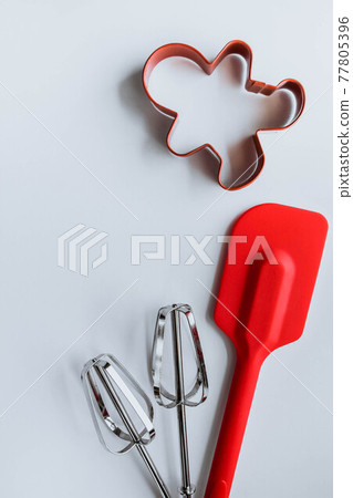 Baking supplies on white. Spatula, mixer whisks, cookie cutter on white background Baking supplies on white. Spatula, mixer whisks, cookie cutter on white background 77805396