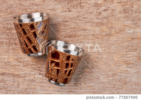 Two hip flask cups close up. Two hip flask cups close up. 77807400