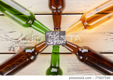 Alcohol dependence concept, wooden table. Alcohol dependence concept, wooden table. 77807590