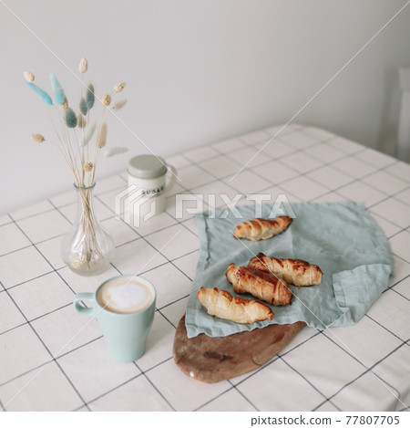 freshly baked homemade pastry on kitchen table. breakfast with coffee and rolls freshly baked homemade pastry on kitchen table. breakfast with coffee and rolls 77807705