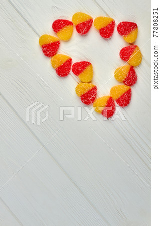 Tasty sugary candies forming shape of heart. 77808251