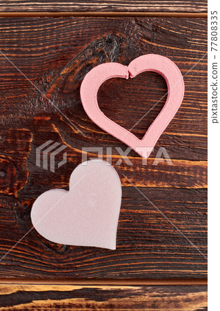 Decorative pink hearts on wooden background. Decorative pink hearts on wooden background. 77808335