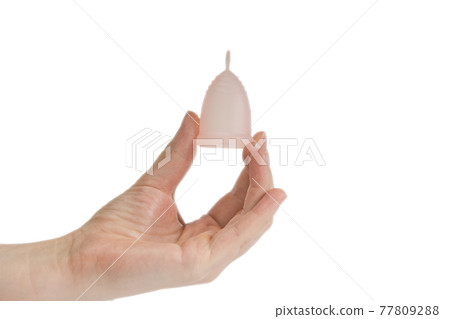 Womans hand holding menstrual cup, period cup isolated on white background with copy space, alternative product zero waste eco friendly 77809288