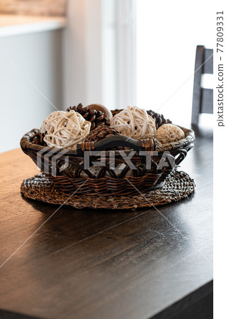 Decorative basket on a wood table 77809331