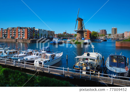 View of the harbour of Delfshaven and the old grain mill De Destilleerketel. Rotterdam, Netherlands View of the harbour of Delfshaven and the old grain mill De Destilleerketel. Rotterdam, Netherlands 77809452