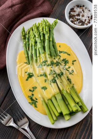 Cooked asparagus with Hollandaise sauce 77809538