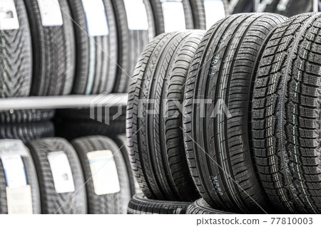 new tires in the service shop against the blurred tire background 77810003