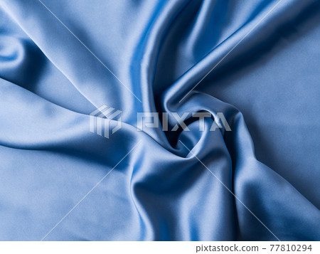 Blue satin texture background with waves and crease Blue satin texture background with waves and crease 77810294