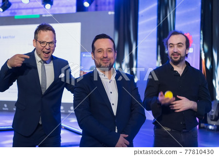 Businessman portrait on conference meeting, presenter joining a seminar via video conference call in empty convention center. Online webinar or seminar via social network broadcast in new normal 77810430