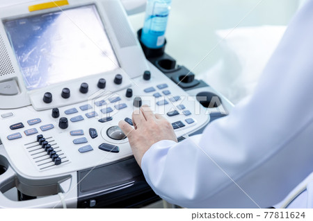 Doctor hand at ultrasound scanner control panel. Doctor hand at ultrasound scanner control panel. 77811624