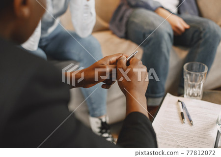 Couple at pshycologist appointment sitting in modern office Couple at pshycologist appointment sitting in modern office 77812072