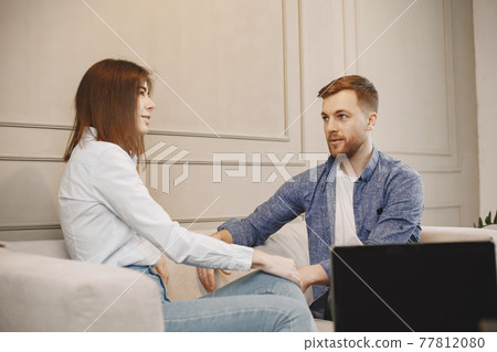 Young woman talking with her male pschycologist Young woman talking with her male pschycologist 77812080