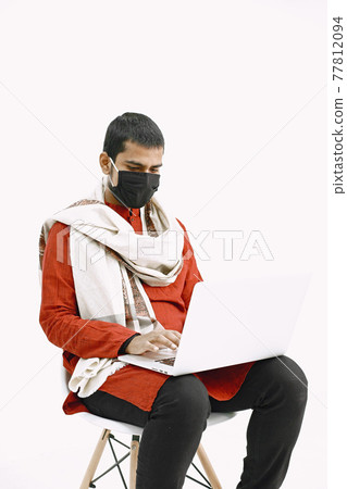 Man in protective mask work with laptop 77812094