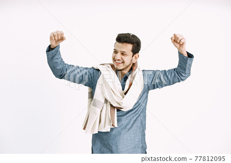 Indian man dancing cheerfully on white backgound 77812095