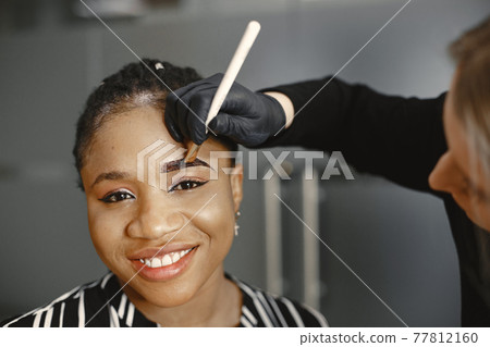 African girl doing eyebrow correction 77812160