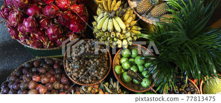 Exotic and tropical fruits on the market of Asia, Thailand, Vietnam. Mini bananas, longan, pitaya, Dragon Fruit, papaya. Exotic and tropical fruits on the market of Asia, Thailand, Vietnam. Mini bananas, longan, pitaya, Dragon Fruit, papaya. 77813475
