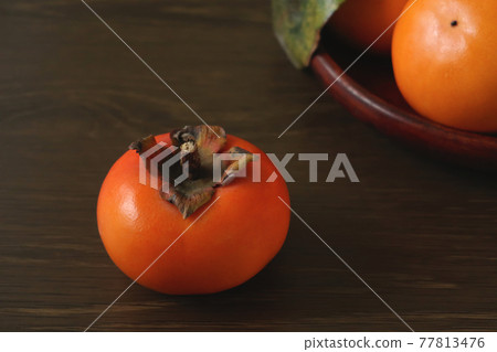 Persimmons on a wooden flat plate 2 Persimmons on a wooden flat plate 2 77813476