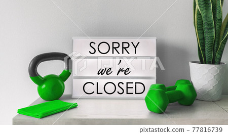 Sorry we are Closed Sign at fitness center gym storefront with training equipment. Shutdown curfew order of restaurants, non essential businesses forcing to bankruptcy with the closing. Coronavirus Sorry we are Closed Sign at fitness center gym storefront with training equipment. Shutdown curfew order of restaurants, non essential businesses forcing to bankruptcy with the closing. Coronavirus 77816739