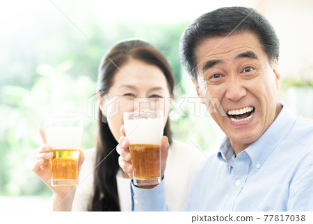 Active senior toasting with beer Active senior toasting with beer 77817038
