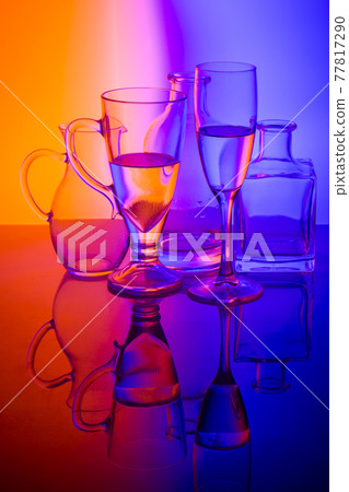 Still life with glass objects on a colored background Still life with glass objects on a colored background 77817290