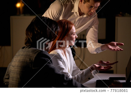 Business team working together until late in office,doing successful work on computer Business team working together until late in office,doing successful work on computer 77818081