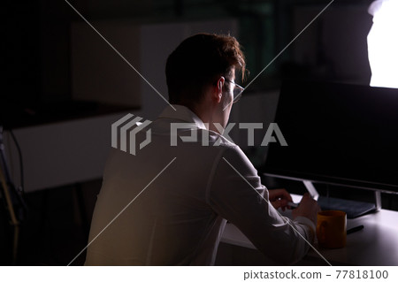 Unrecognizable Male Programmer Writing Code on Computer at Night Sitting At Table Unrecognizable Male Programmer Writing Code on Computer at Night Sitting At Table 77818100