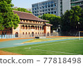 Midsummer playground and old buildings beside it 77818498