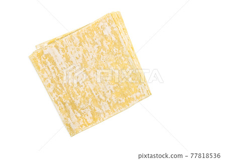 Top view stack of Wonton or Chinese dumpling sheets, image with clipping path, isolated yellow dumpling sheets on white background. 77818536