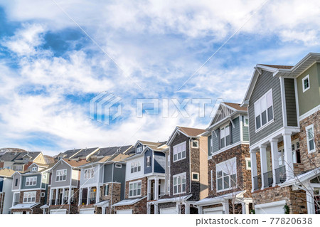 Charming houses in the valley with blue sky and clouds background on a sunny day 77820638