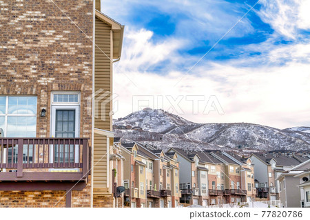 Real estate landscape with townhouses overlooking snow dusted Wasatch Mountain 77820786