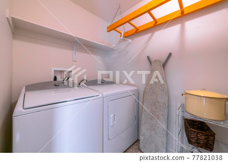 Interior of the laundry room of home with washing machine and dryer appliances 77821038