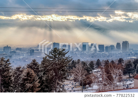Sunlight beaming through overcast sky over downtown Salt Lake City landscape 77822532