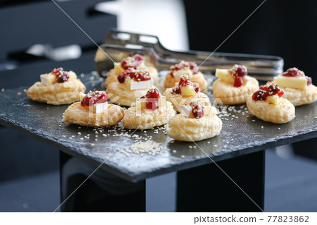 Set of sweet desserts for catering, dessert on a black plate. 77823862