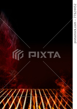 Empty steel barbecue BBQ grill grate with burning fire and smoke against black background. Cooking concept. Close up, copy space Empty steel barbecue BBQ grill grate with burning fire and smoke against black background. Cooking concept. Close up, copy space 77824452