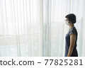 Asian female tourists wear gray clothes, glasses and face masks in State Quarantia. 77825281