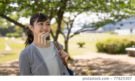 Business woman smiling outside 77825307