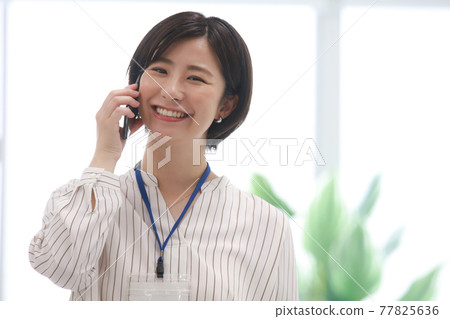 Female employee talking on the phone 77825636