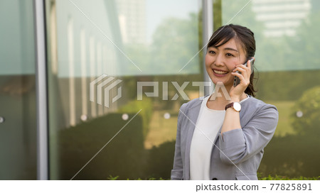 Business woman making a work call Business woman making a work call 77825891