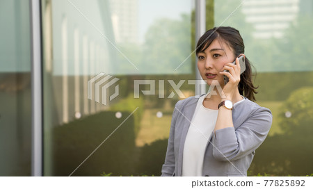Business woman making a work call Business woman making a work call 77825892