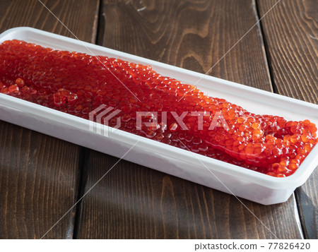 "Sujiko" using salmon roe. Fresh Sujiko in a plastic container. 77826420