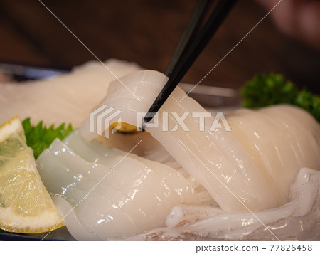 Fresh sliced squid sashimi. 77826458