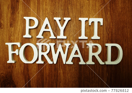 Pay It Forward alphabet letter on wooden background 77826812