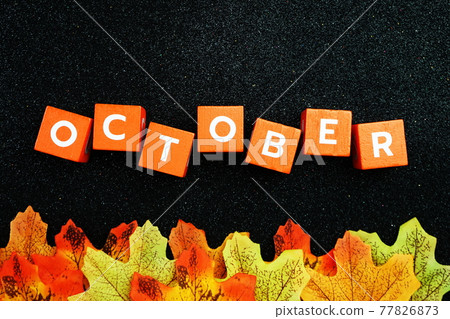October alphabet letter with maple leave decoration on black glitter background October alphabet letter with maple leave decoration on black glitter background 77826873