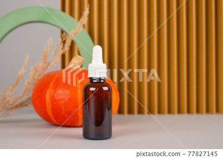 Still life composition with dropper bottle of natural organic cosmetics - pumpkin seed oil extract for skincare or hair with pumpkins and plaster models. Beauty treatment, natural cosmetics concept Still life composition with dropper bottle of natural organic cosmetics - pumpkin seed oil extract for skincare or hair with pumpkins and plaster models. Beauty treatment, natural cosmetics concept 77827145