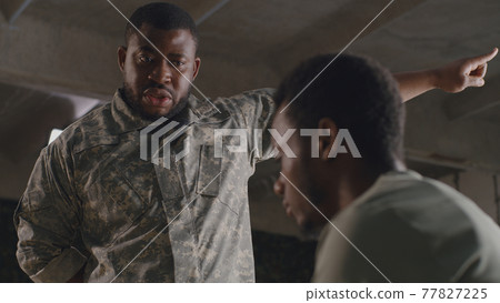 African American commander scolding soldier 77827225