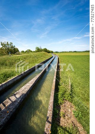 Two Small Concrete Irrigation Canals a Rural Scene - Padan Plain Italy Two Small Concrete Irrigation Canals a Rural Scene - Padan Plain Italy 77827485