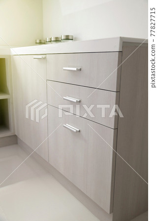 Close up of kitchen cabinets with metal pulls or knobs on the doors. Close up of kitchen cabinets with metal pulls or knobs on the doors. 77827715