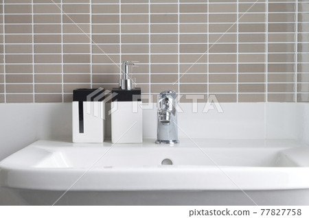 Modern white bathroom sink basin. Interior of bathroom with sink and soap dispenser. Modern design of bathroom. Modern white bathroom sink basin. Interior of bathroom with sink and soap dispenser. Modern design of bathroom. 77827758