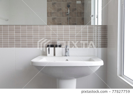 Modern white bathroom sink basin. Interior of bathroom with sink and soap dispenser. Modern design of bathroom. Modern white bathroom sink basin. Interior of bathroom with sink and soap dispenser. Modern design of bathroom. 77827759